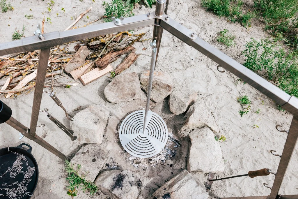 SolidFireKitchen aus Edelstahl — Aufbau über steinernem Feuerring am Wasser
